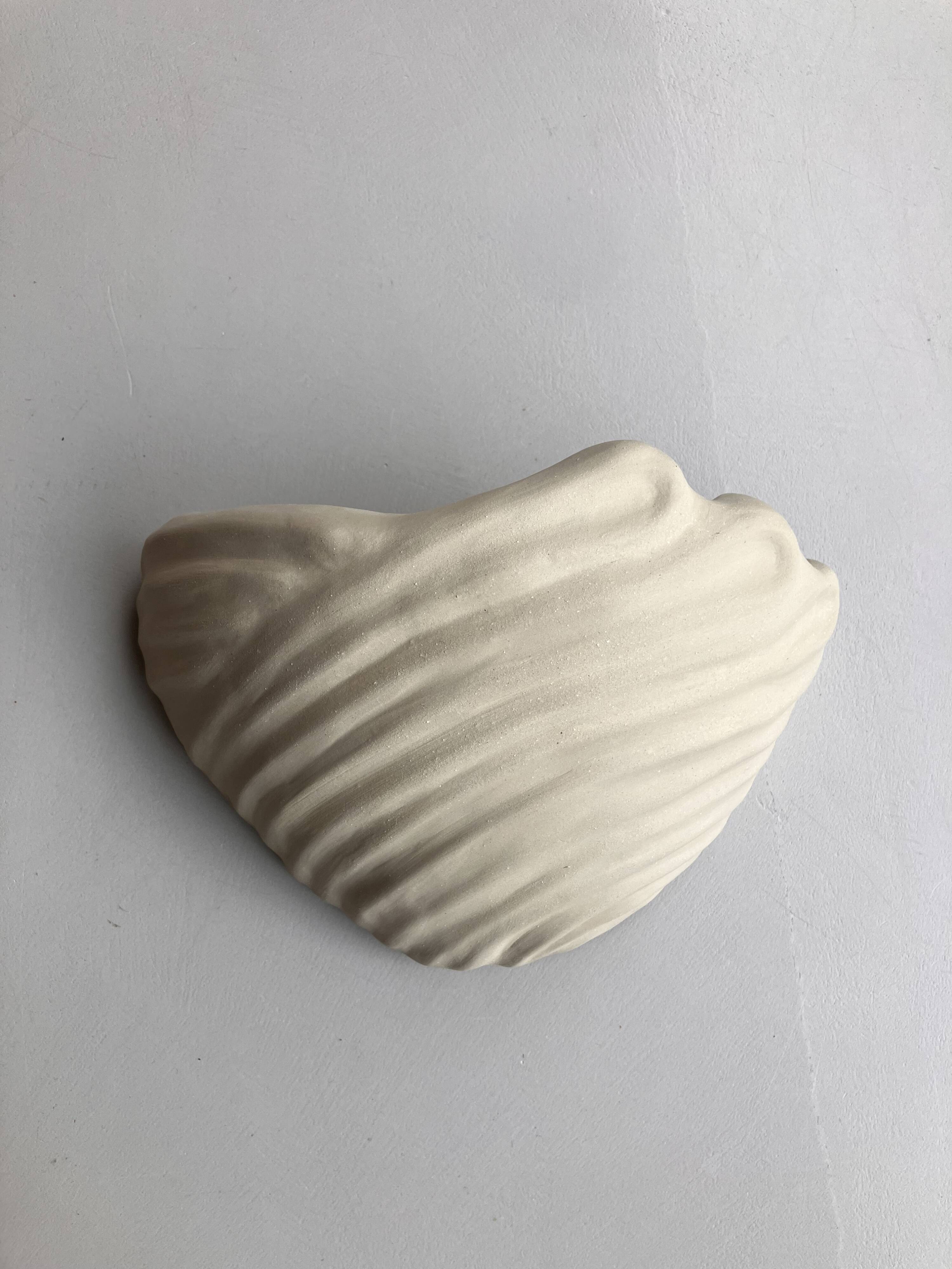 Shell-shaped ceramic applique handcrafted.