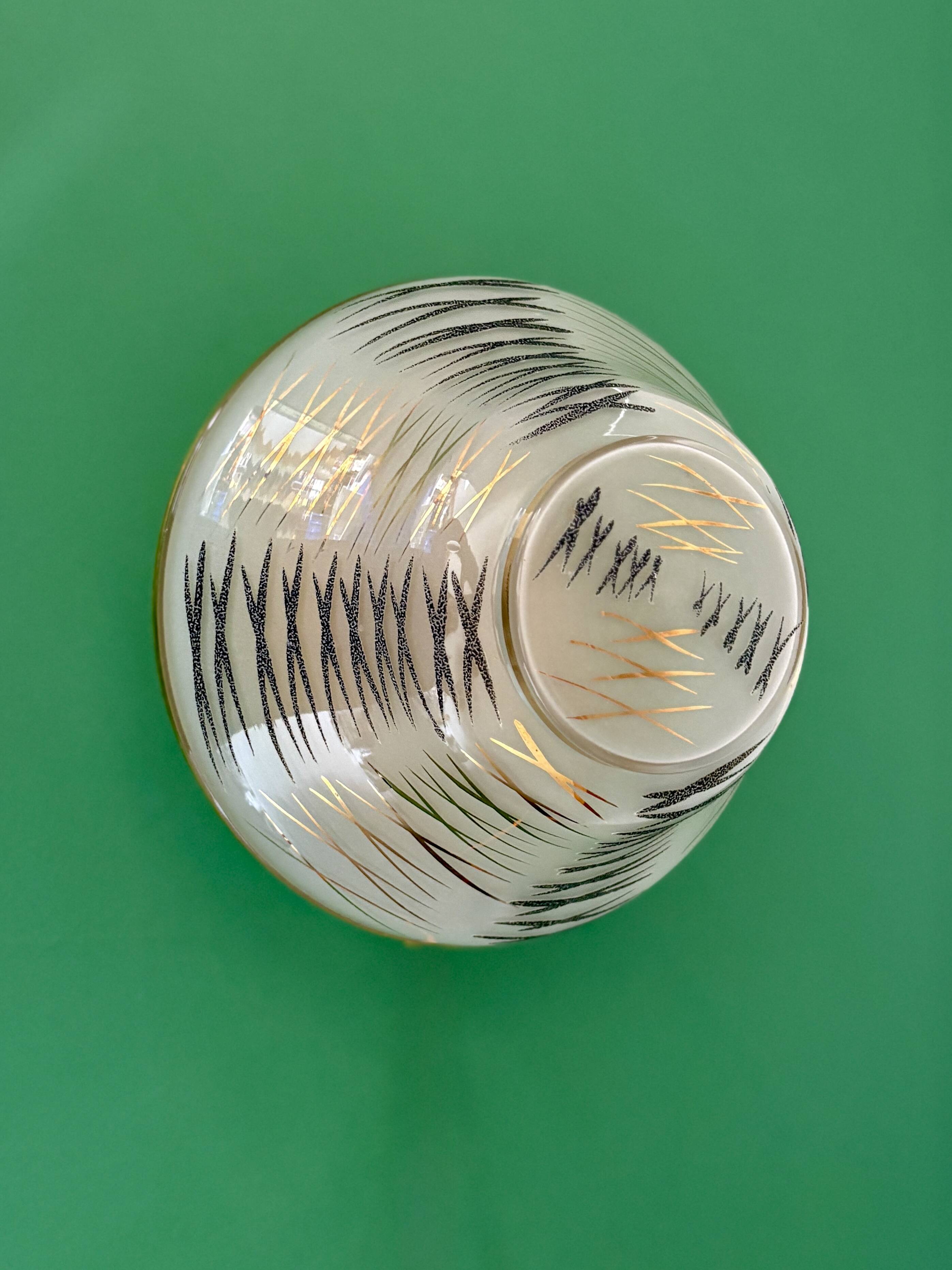 Vintage Art Deco globe wall/ceiling light in white, black, and gold glass.