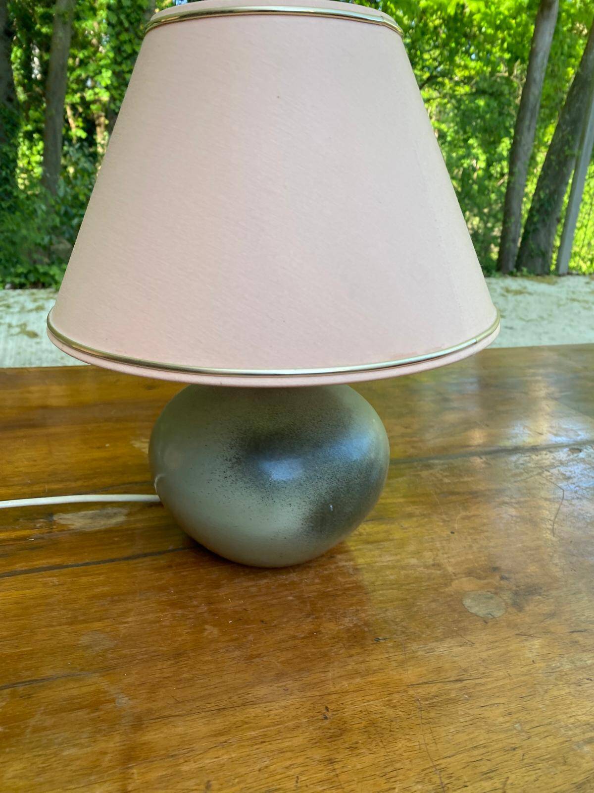 Vintage green ceramic bedside lamp with a pink-beige lampshade.