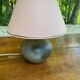 Vintage green ceramic bedside lamp with a pink-beige lampshade.
