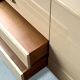 Commode type sideboard with 8 drawers, ivory lacquer and brass details, 1970s design.