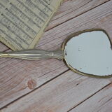 Antique hand mirror with stitched glass