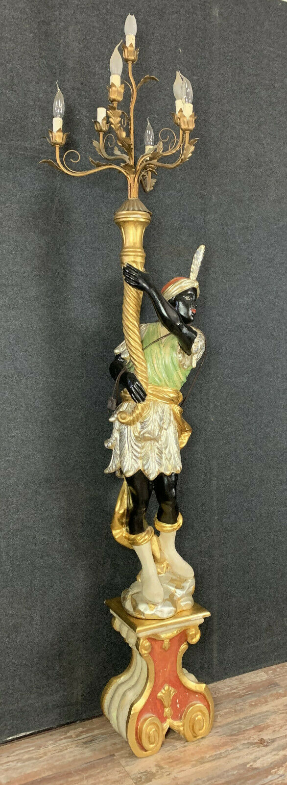 Early XXth era polychrome wooden torch has figuration of a Moor in traditional costume from the 18th