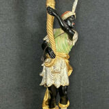Early XXth era polychrome wooden torch has figuration of a Moor in traditional costume from the 18th