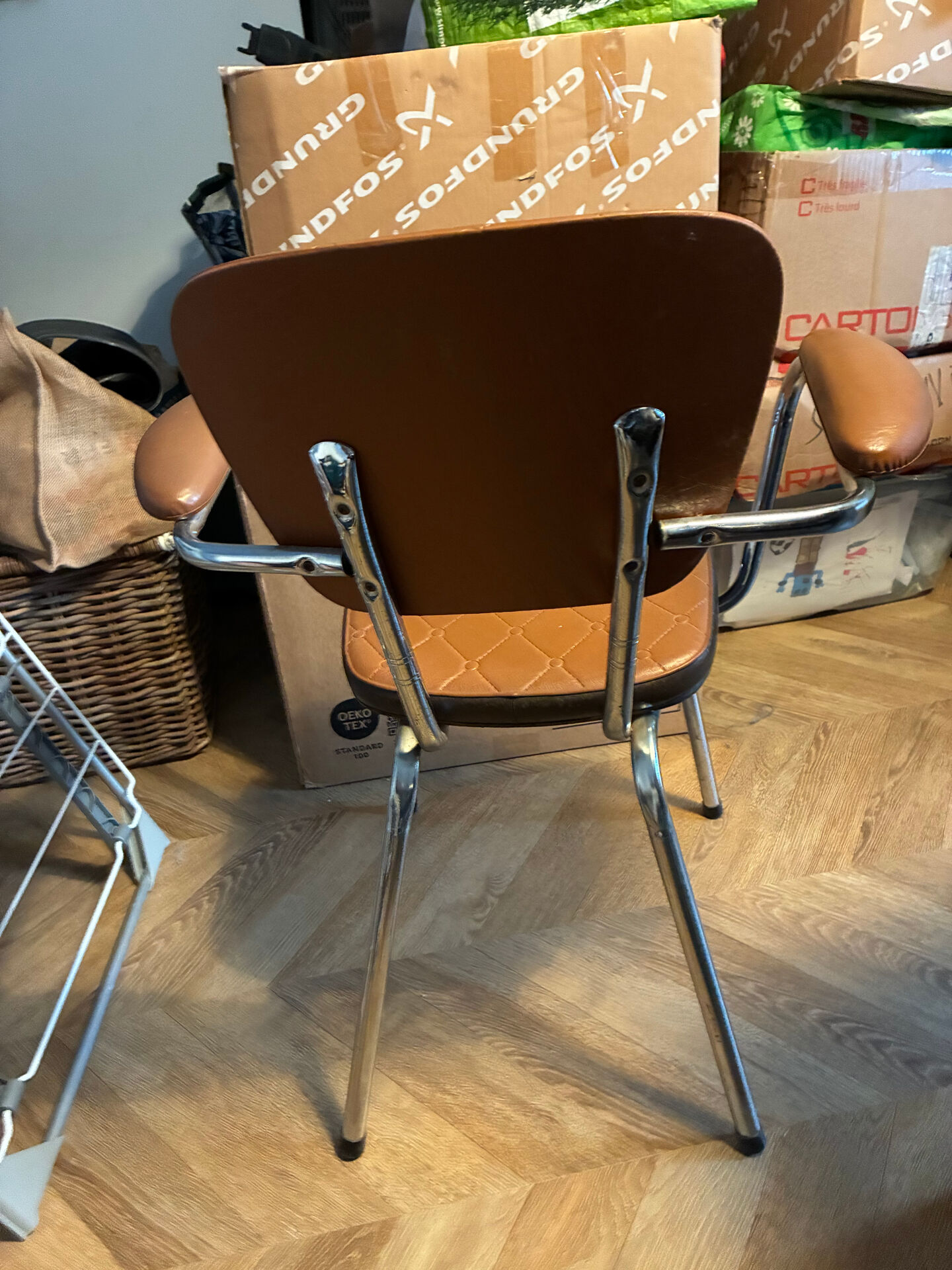 Armchair with armrests from the 70s in Skai and chrome.