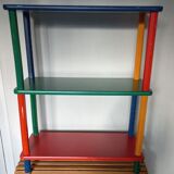 Shelf on legs, library, crayons in 4 colours.