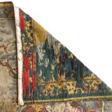 Wall tapestry featuring a pastoral scene.