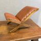 Old retro footstool, mid-century wooden leather stool, mid 20th century, European