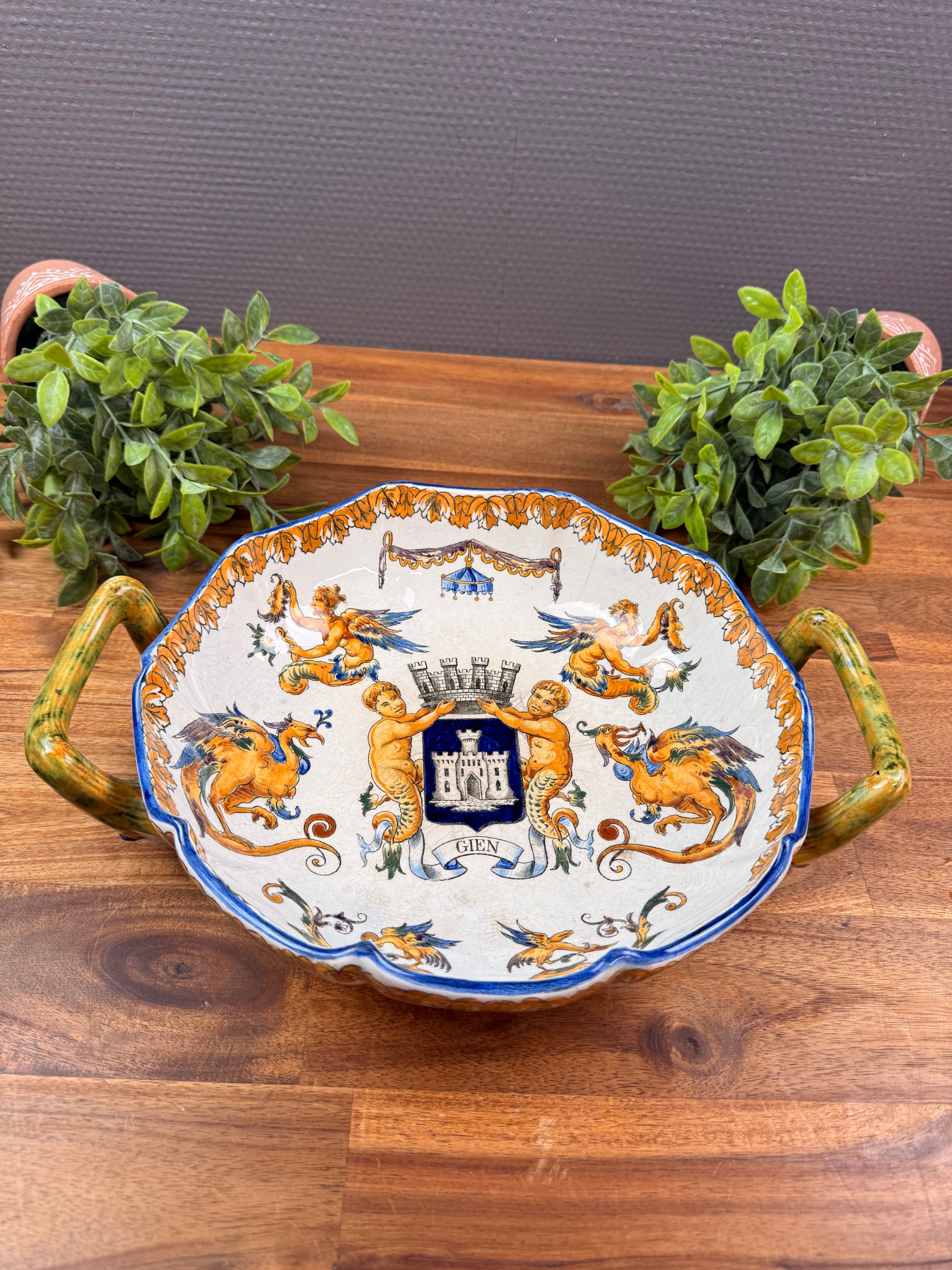 Handled coupe in Gien earthenware with heraldic and fantastic decoration.