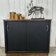 Small vintage black buffet with sliding doors.
