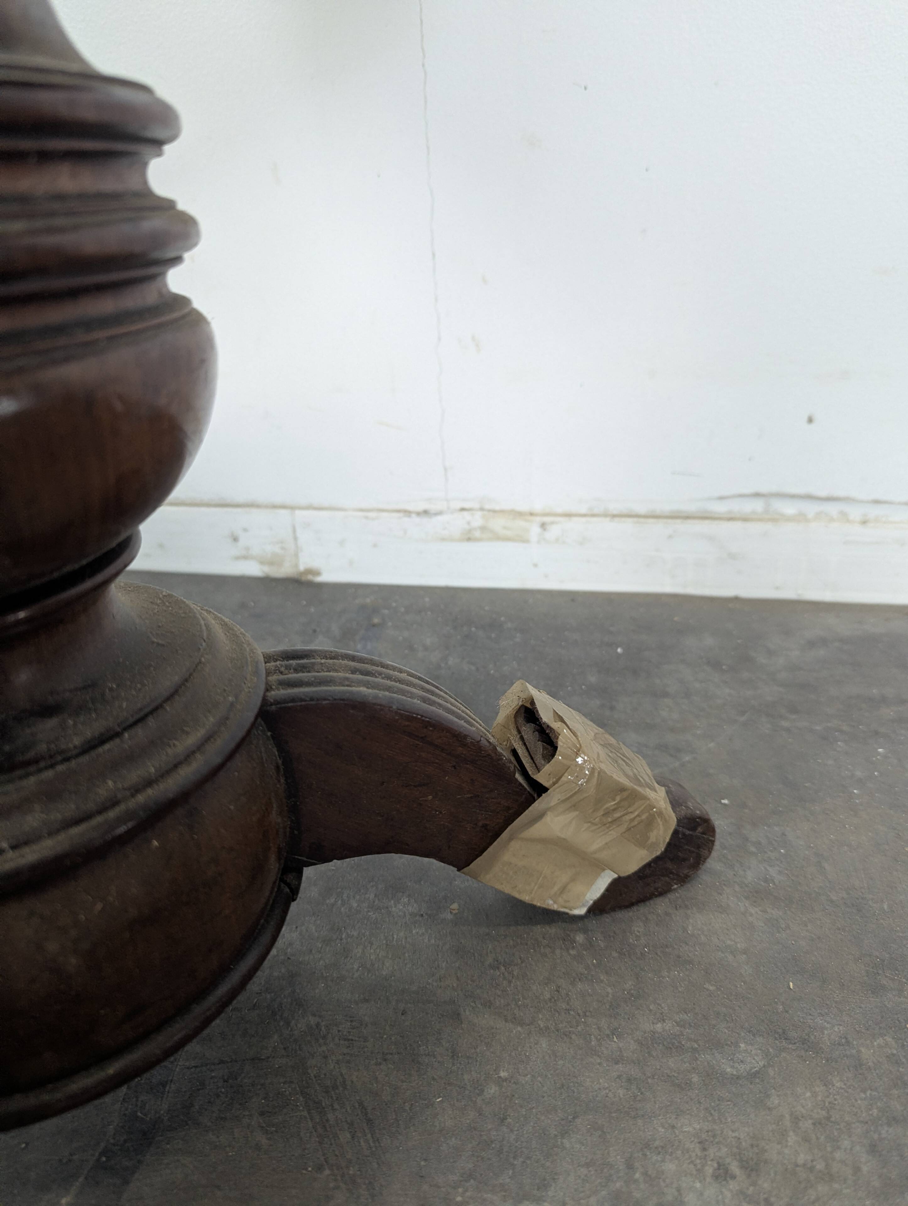 Green velvet piano stool with a turned leg.