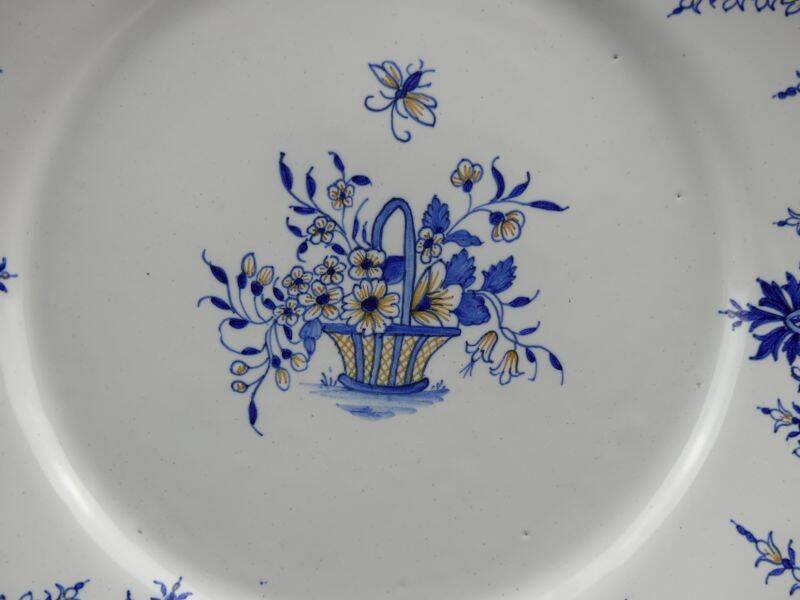 Old earthenware dish with a floral basket decoration.