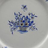 Old earthenware dish with a floral basket decoration.