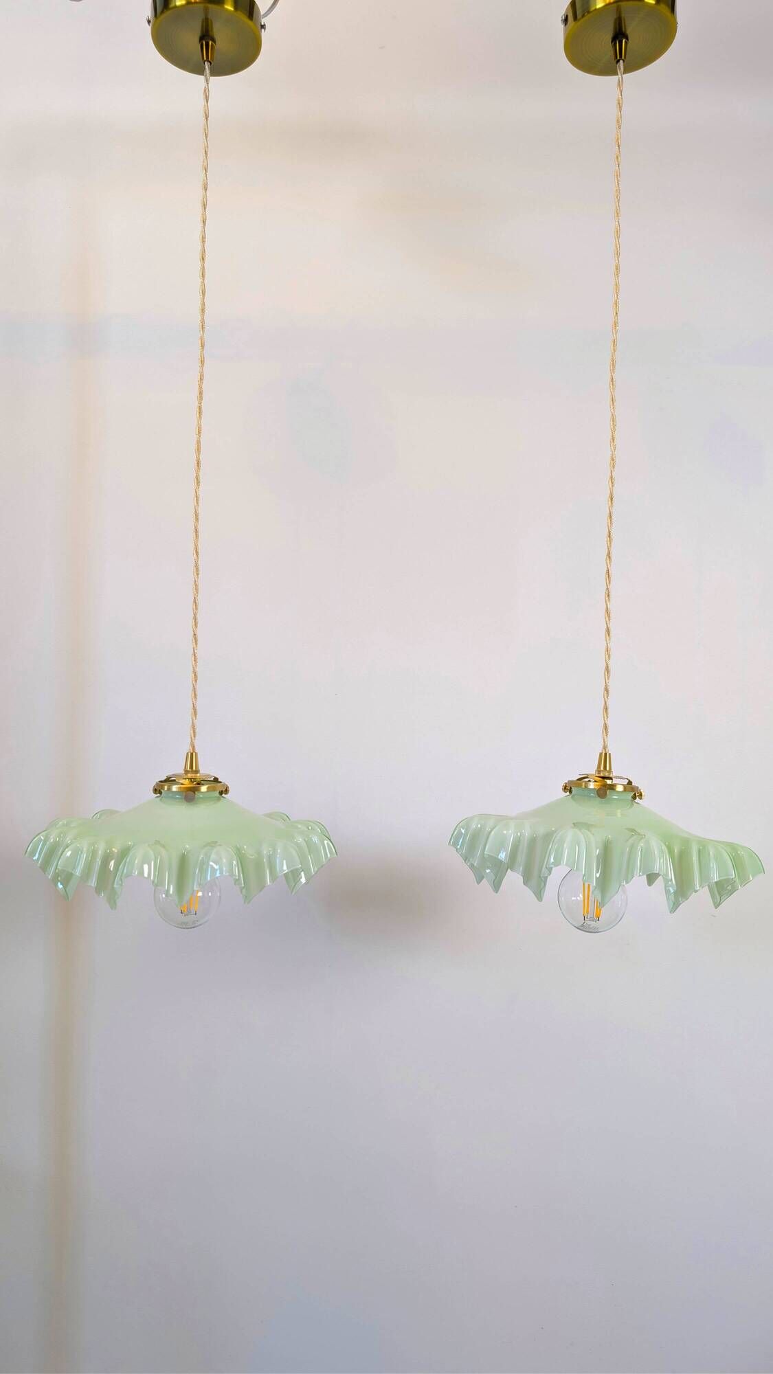 Pair of green opaline glass pendant lights – frosted poetry & Art Deco brilliance