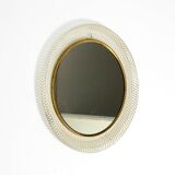 Mid Century Modern round wall mirror with a white expanded metal frame