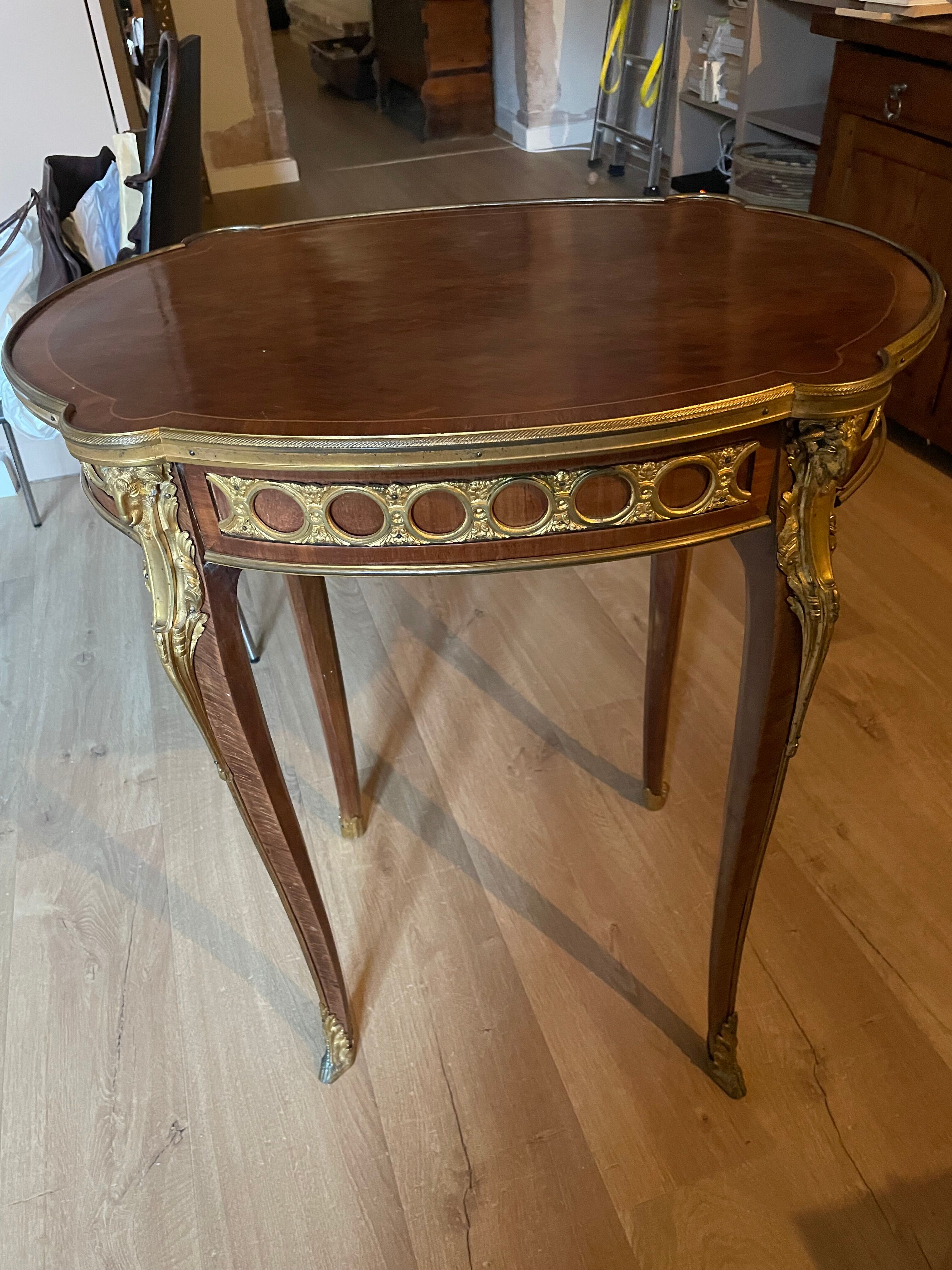Living room table in Louis XV-Louis XVI transitional style with marquetry and bronze.
