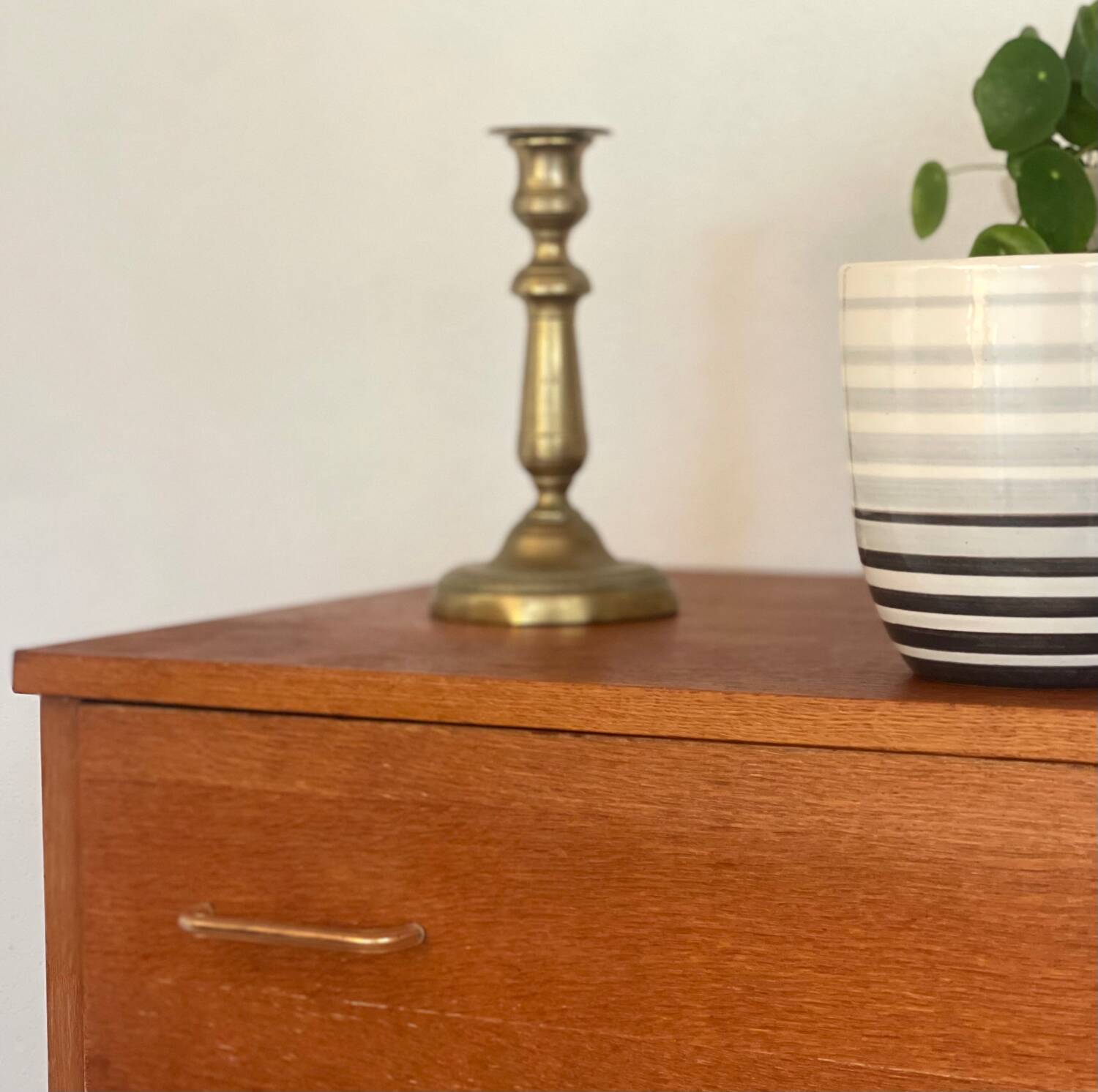 Vintage 1960s chest of drawers with covered handles.
