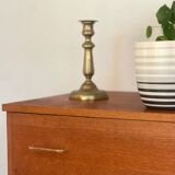Vintage 1960s chest of drawers with covered handles.