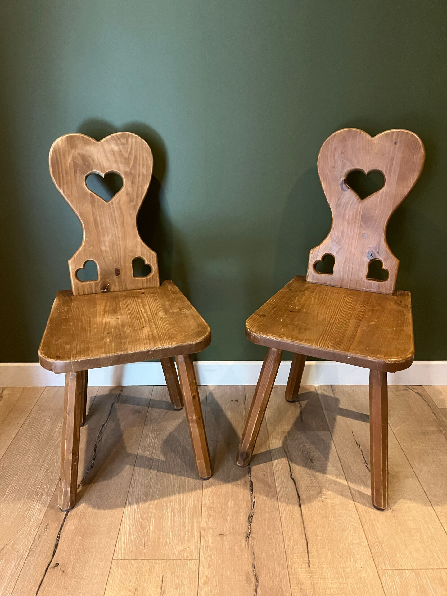 Pair of vintage wooden chairs in alpine chalet style.