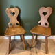 Pair of vintage wooden chairs in alpine chalet style.