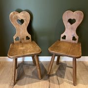 Pair of vintage wooden chairs in alpine chalet style.