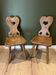 Pair of vintage wooden chairs in alpine chalet style.