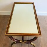 Coffee table in patinated and gilded carved wood with mirror top