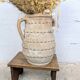 Terracotta jar with two handles, decorated with garlands.