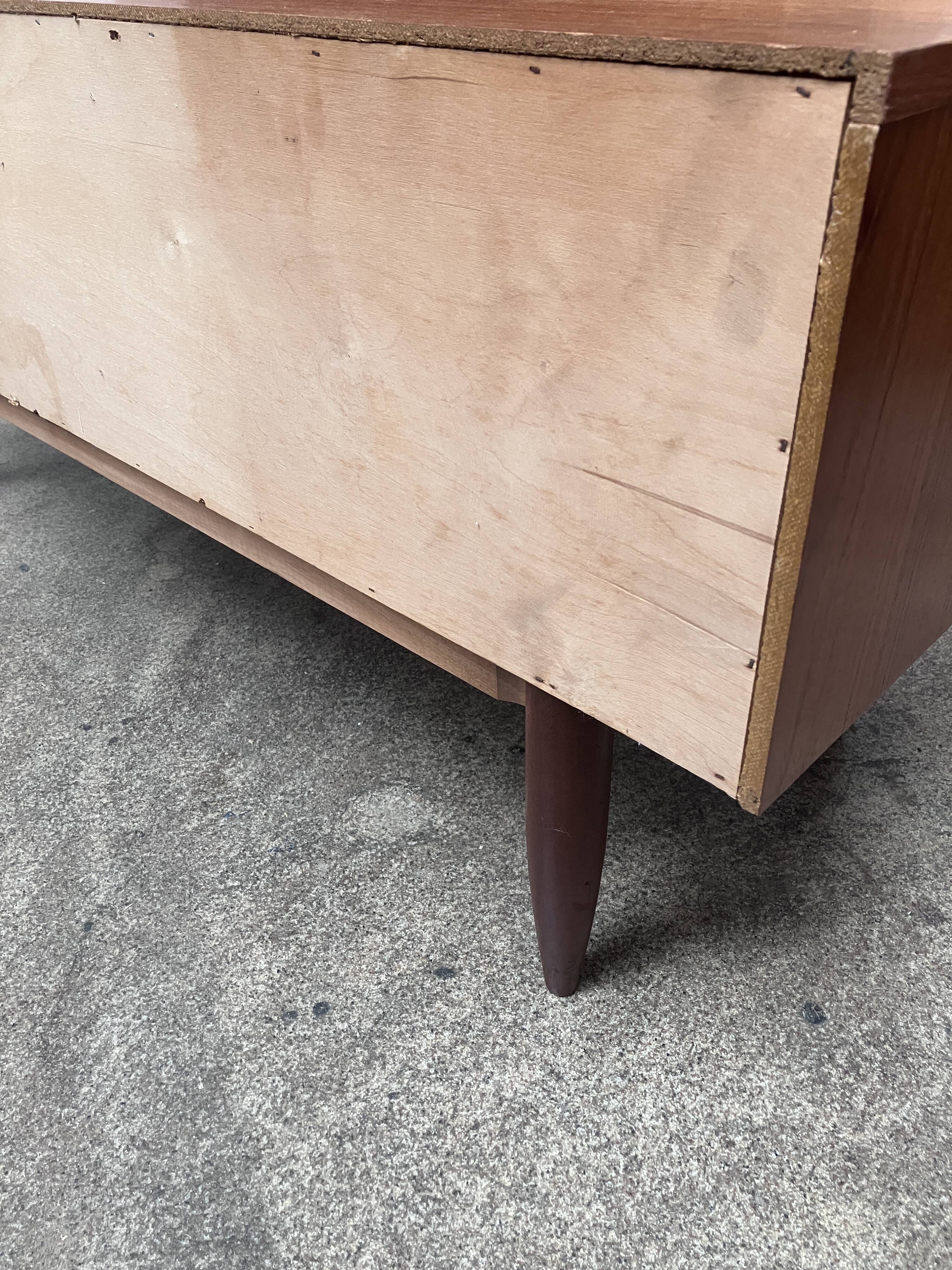 Teak sideboard with flap, 2 drawers and conical legs.