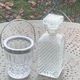 Whiskey carafe and ice bucket in transparent glass and silver-colored metal handle