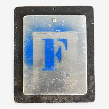 Letter F on metal plates