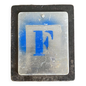Letter F on metal plates