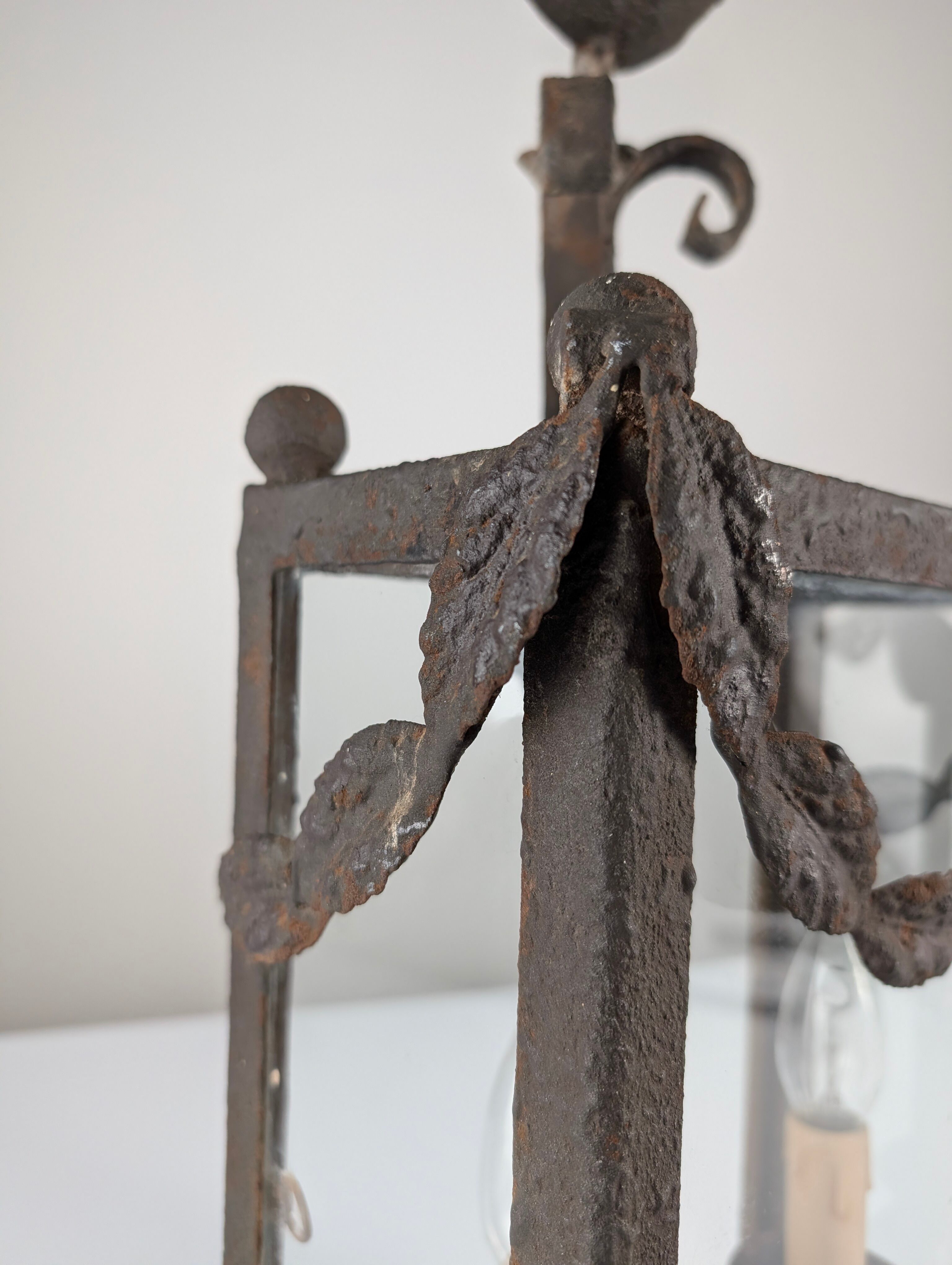 Wrought iron lantern with glass panels, leaf motifs