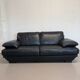 Two-seater Natuzzi sofa in navy blue leather.