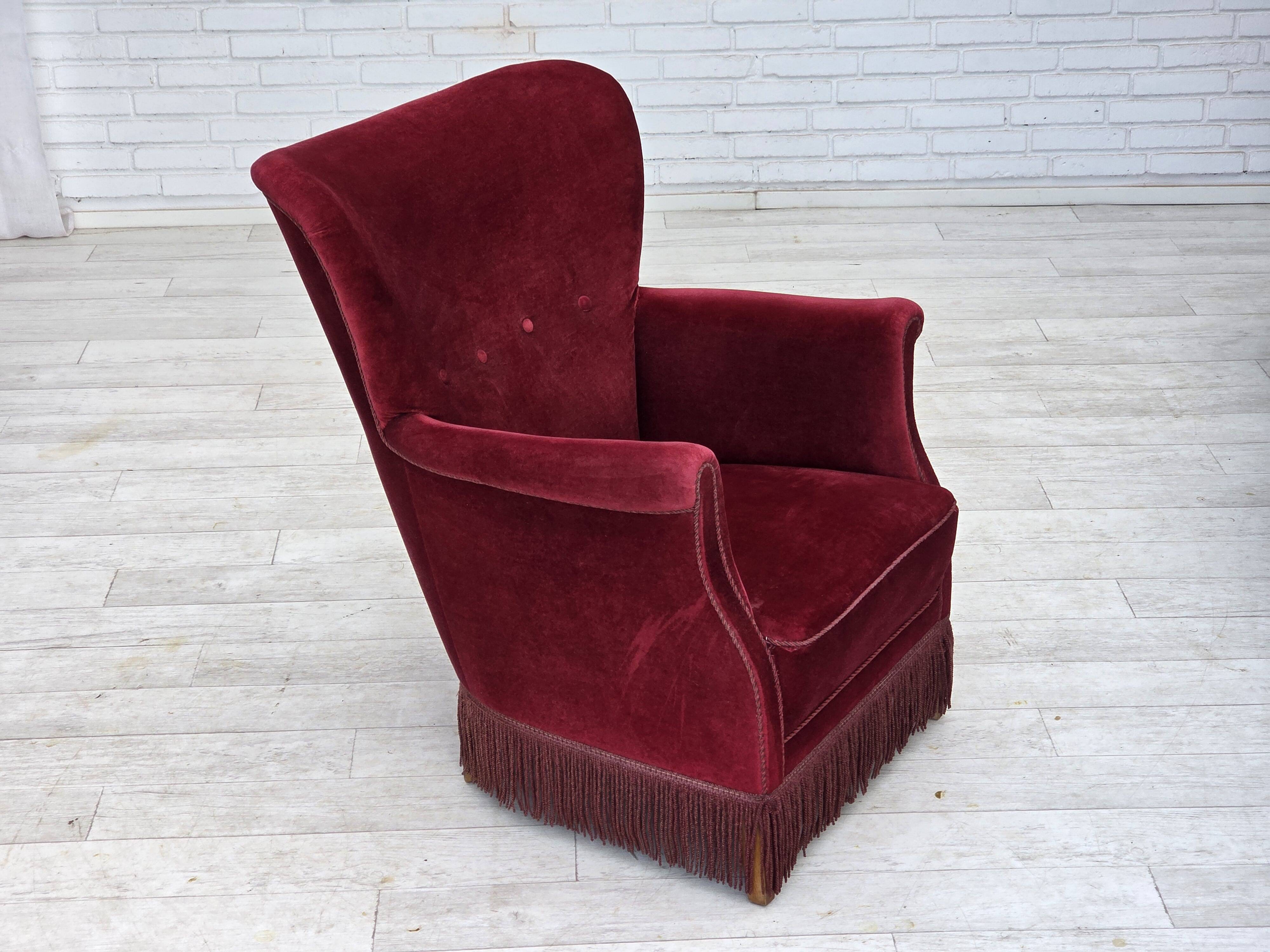 1970s, Danish armchair, cherry-red furniture velour, oak wood legs.