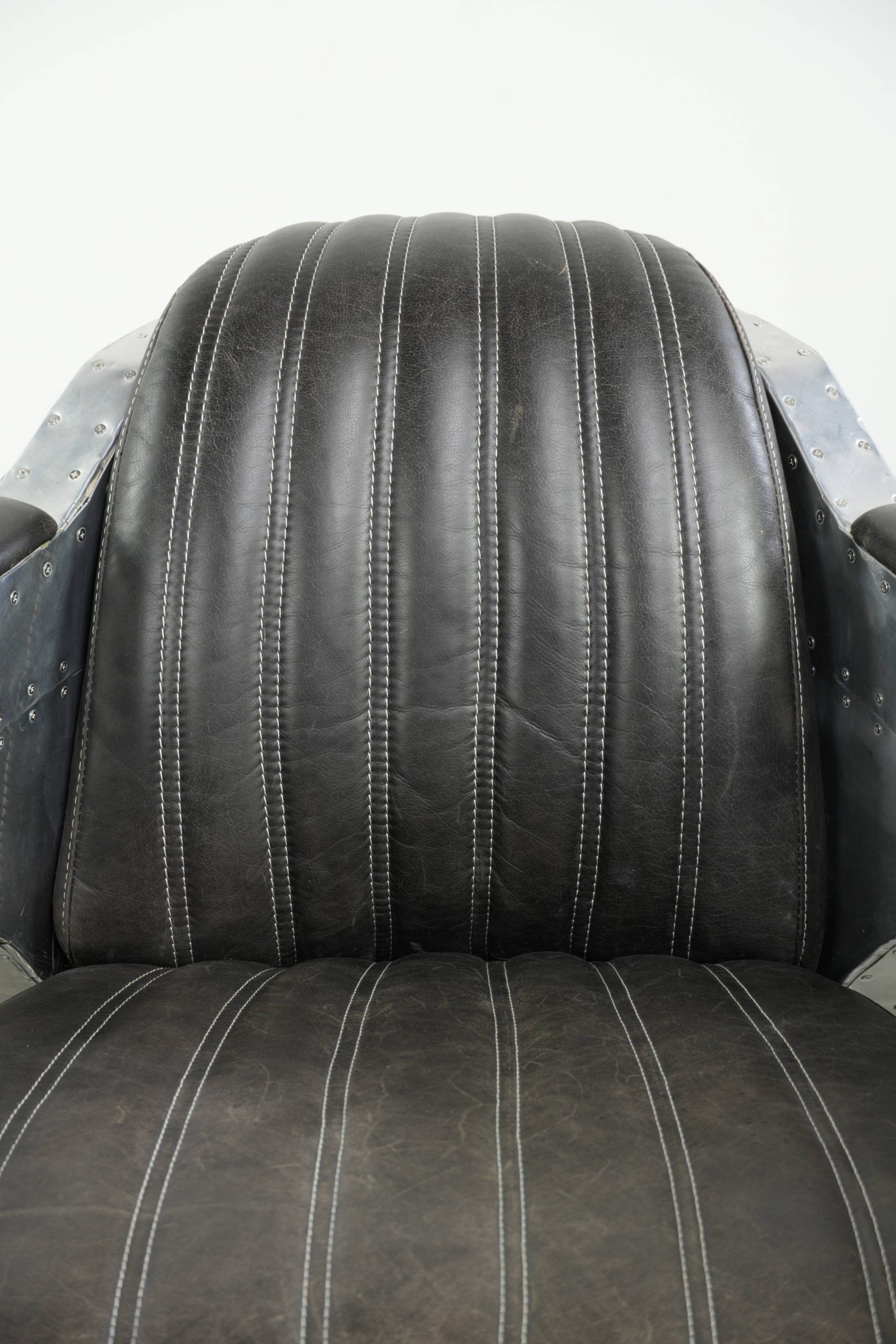 Cow leather aviator design armchair finished with aluminium and rivets