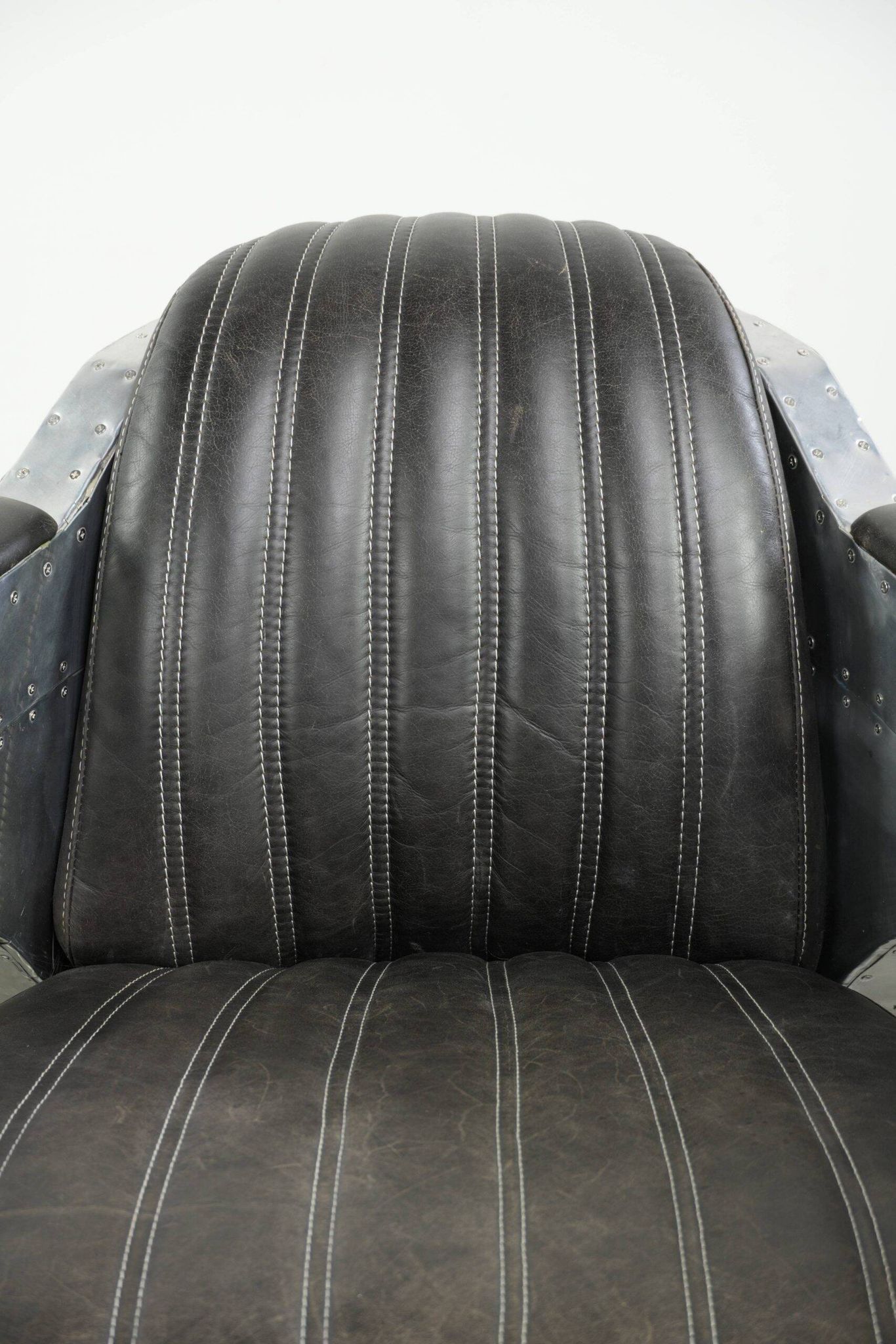 Cow leather aviator design armchair finished with aluminium and rivets