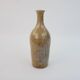 Brown ceramic/stoneware bottle with chiseled floral pattern