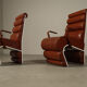 Pair of sculptural cognac leather armchairs, 1970s