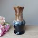 Vintage 1960s brown and blue flame-patterned stoneware wine jug carafe.