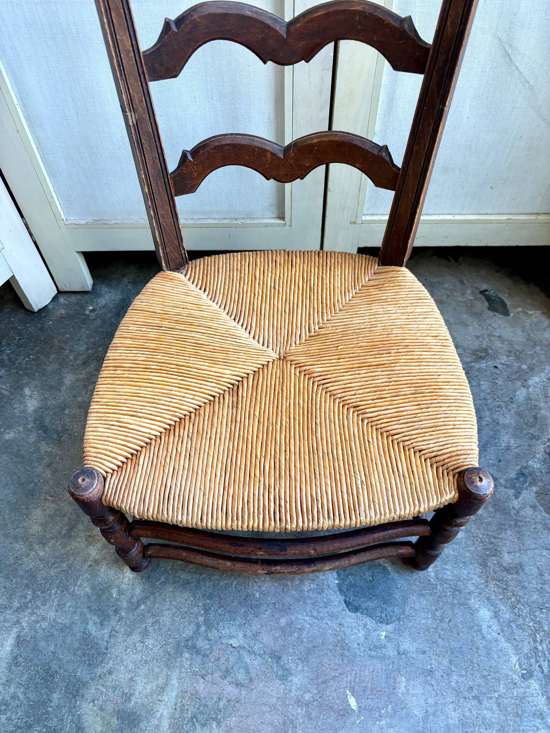 Low Provencal chair in dark wood and woven straw