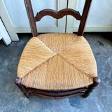 Low Provencal chair in dark wood and woven straw