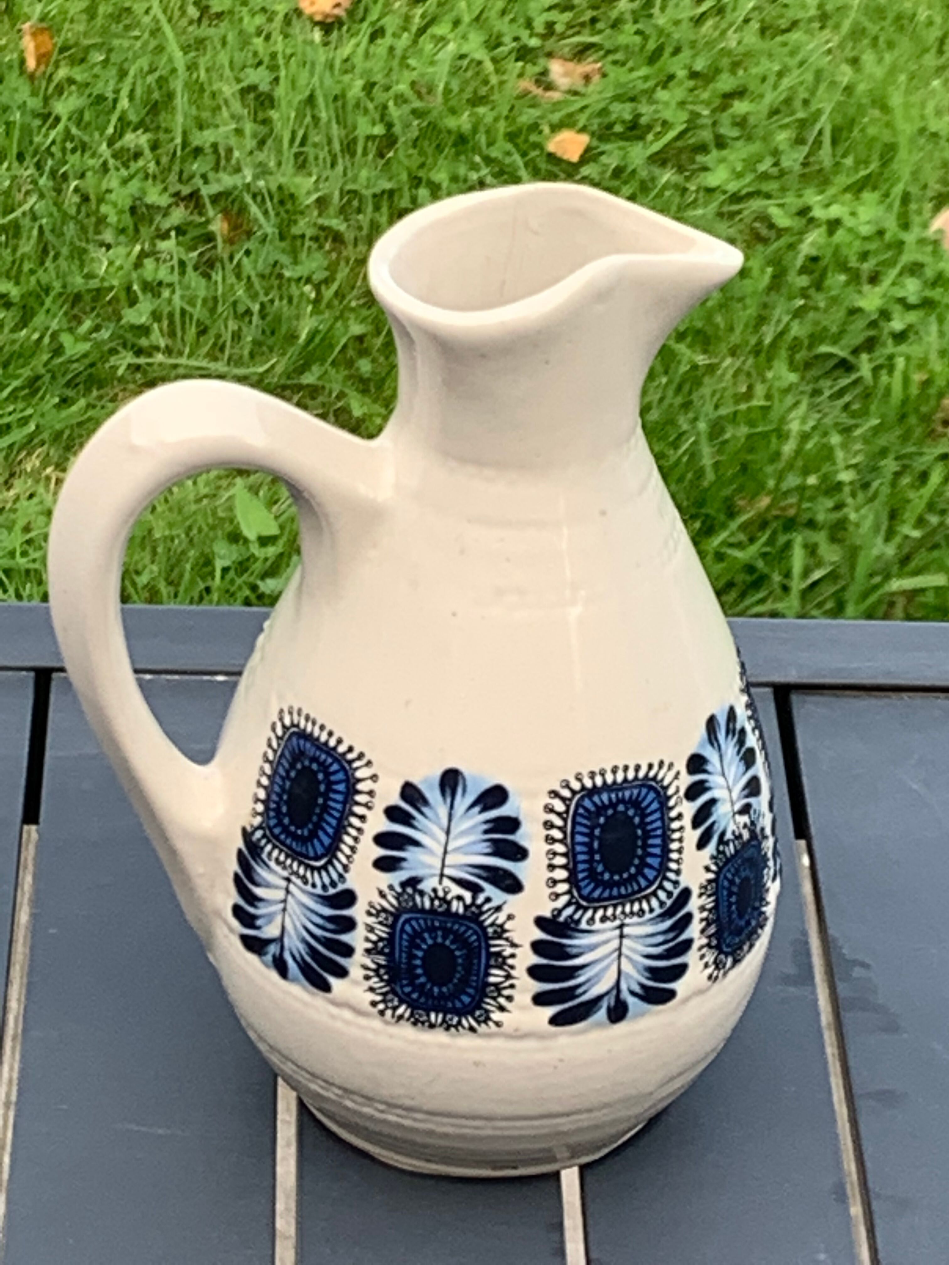 Enamelled sandstone carafe with a nice pattern of vintage blue flowers and 1970 design