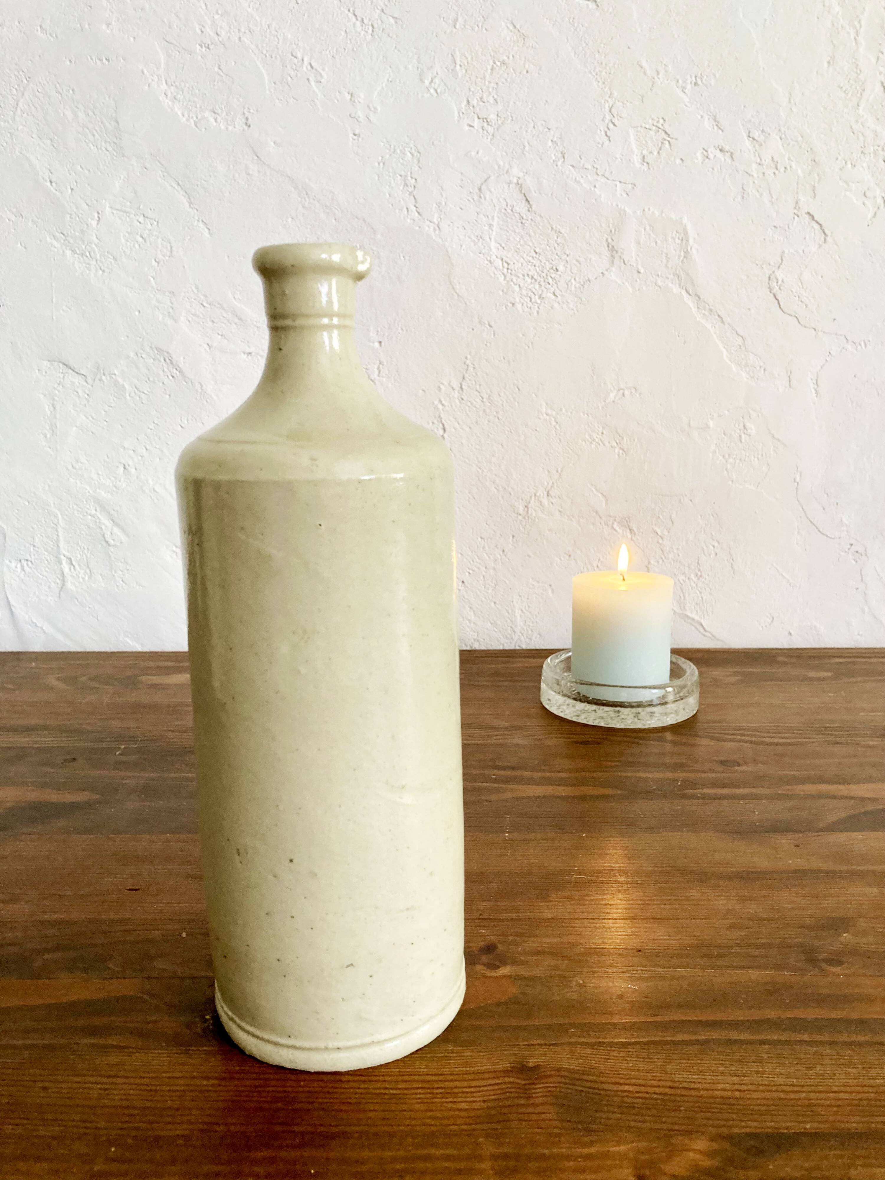 Trio of creamy white glazed stoneware bottles