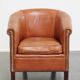 English club chair in light cognac cowhide leather.