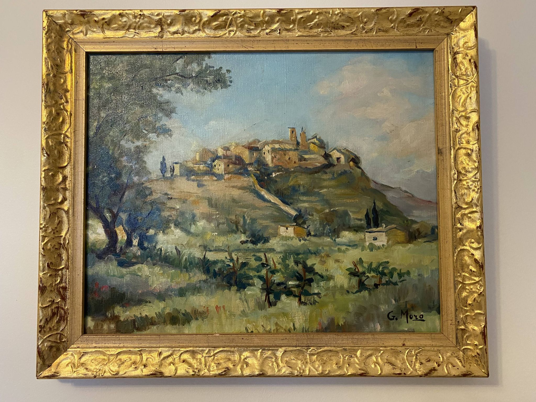 A painting representing a village in Tuscany.