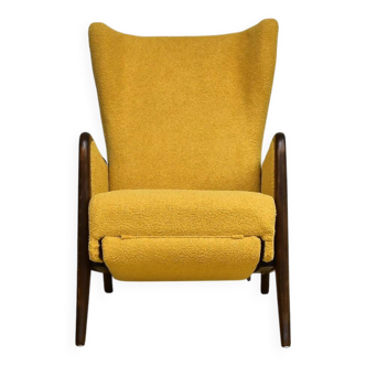 Wingback armchair with folding footrest in yellow bouclé, 1950s