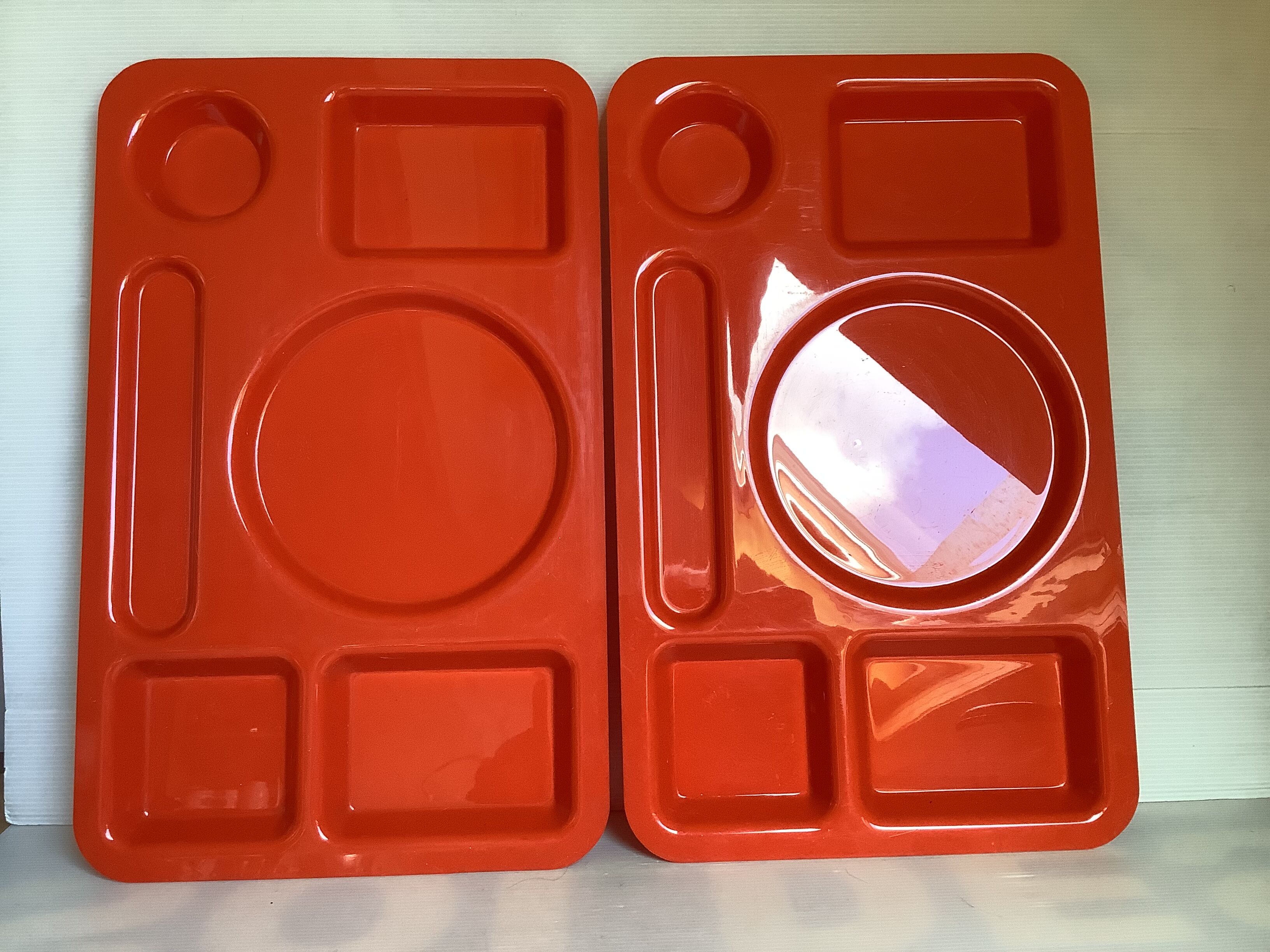 Pair of orange guzzini meal trays