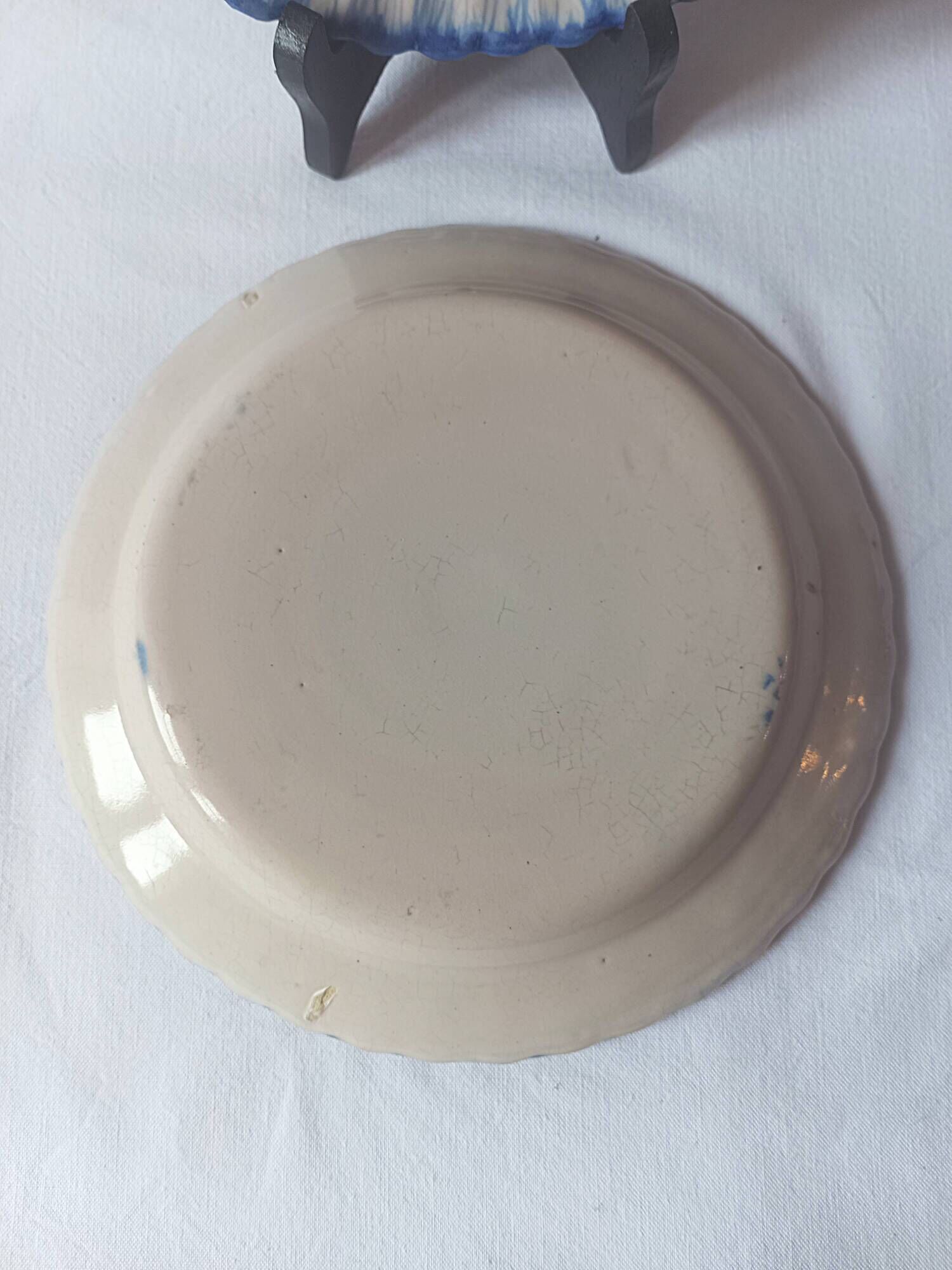 Pair of antique plates in popular earthenware with a floral basket decoration on the edge.