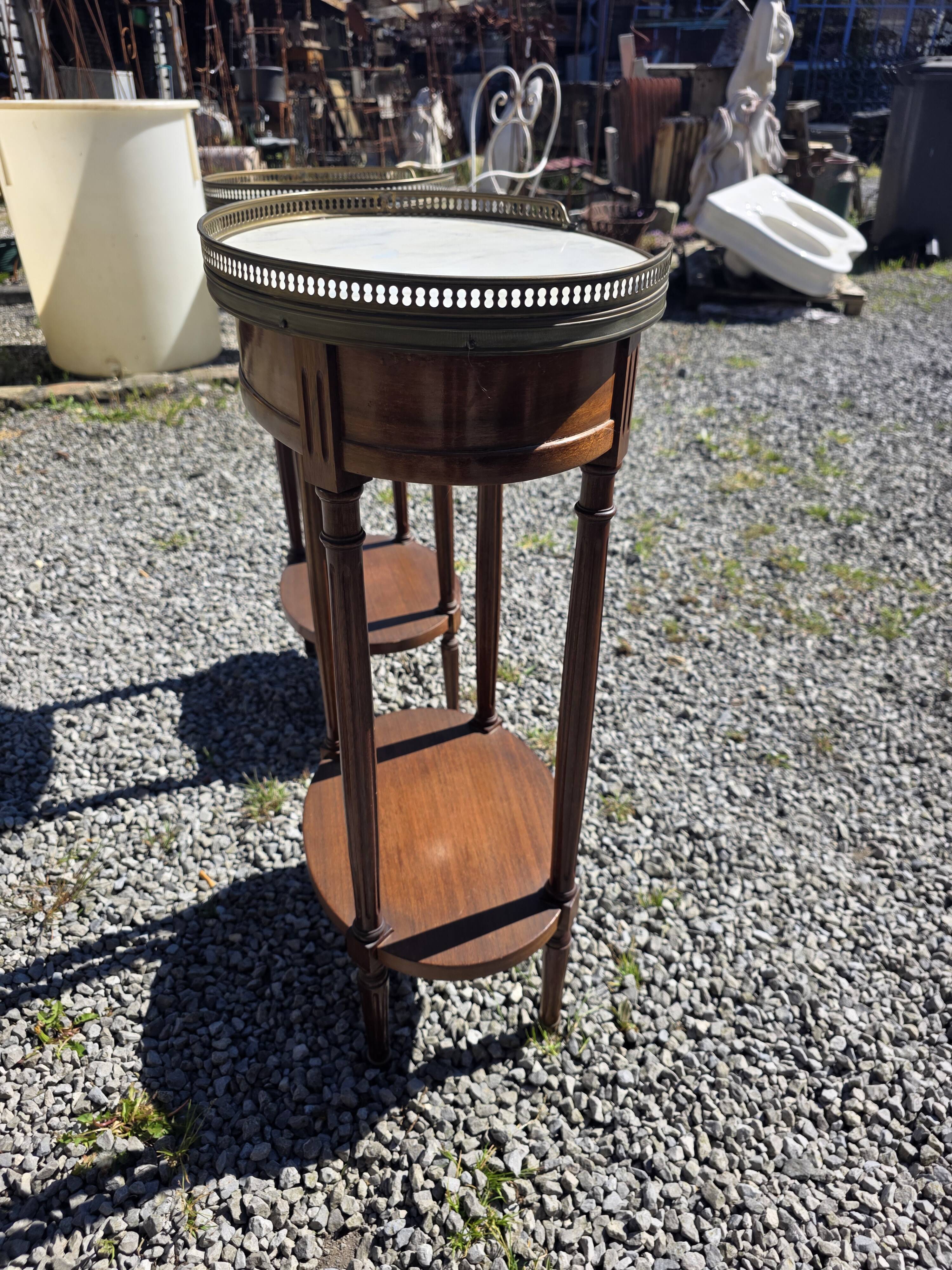Pair of Louis XVI style bedside tables in mahogany, with marble tops.